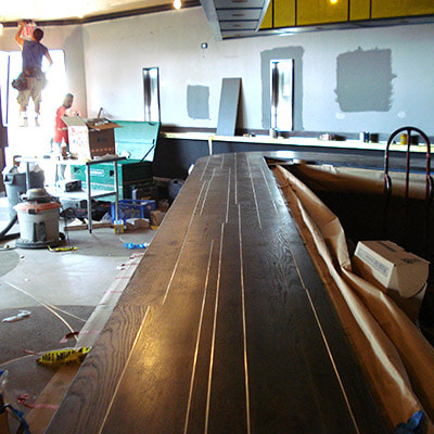 L.A. CONSTRUCTION CRAFT custom built bar for a restaurant, stained brown, another angle view
