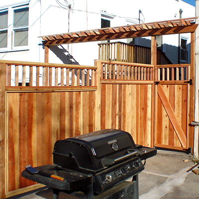 LA Construction Craft custom fence and RV gate with decorative arbor. Corner view with ancillary bar-b-que